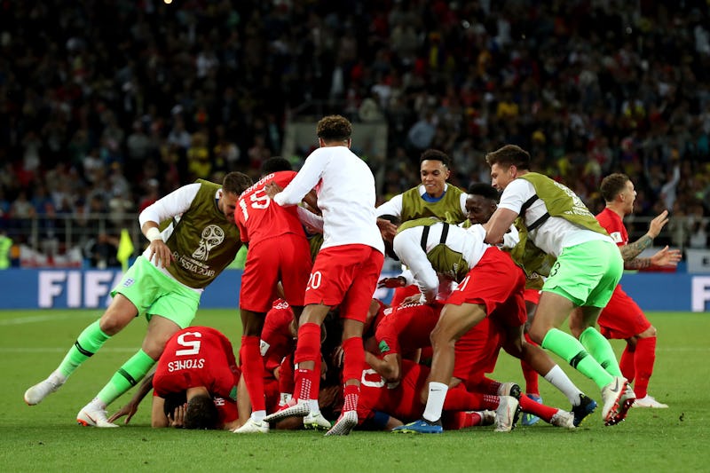 Football players throwing themselves at each other on the ground