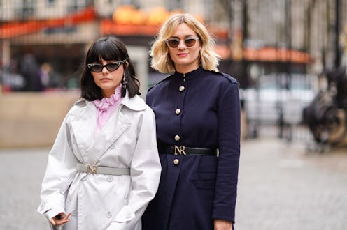 Two models in fall outfits consisted of a white and a dark blue jacket and sunglasses