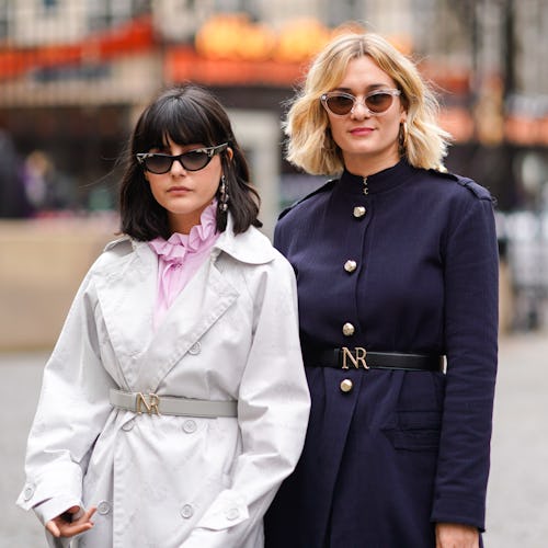 Two models in fall outfits consisted of a white and a dark blue jacket and sunglasses