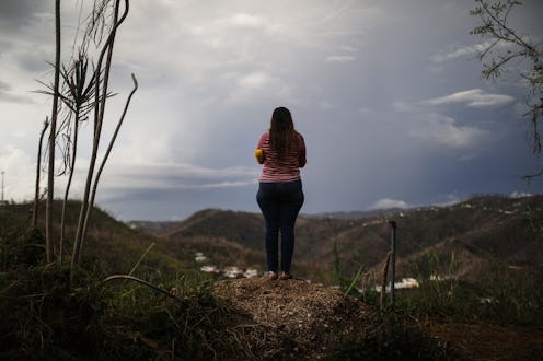 a Midwife after Hurricane Maria standing on top of hill looking down on the landscape