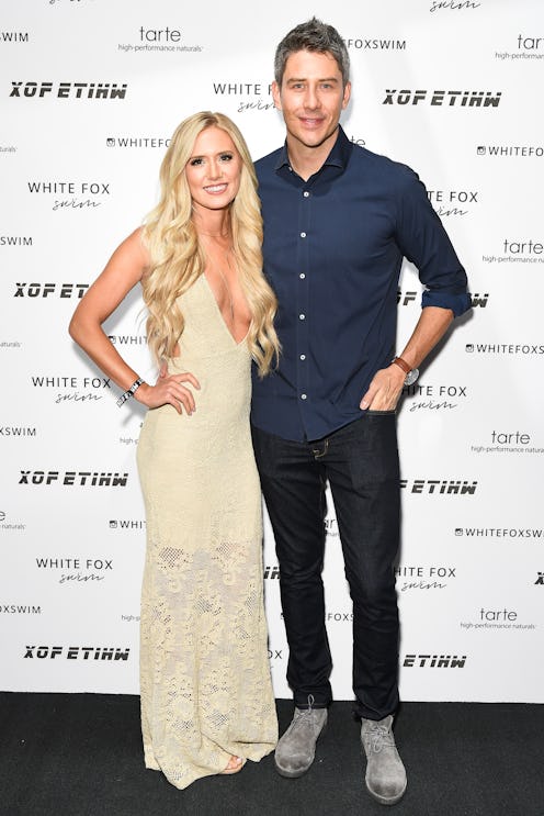 Lauren Burnham and Arie posing for a photographer in front of the white background