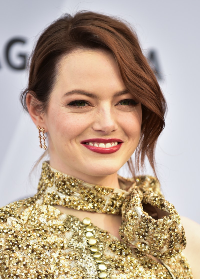 American actress Emma Stone in a gold embellished blouse 
