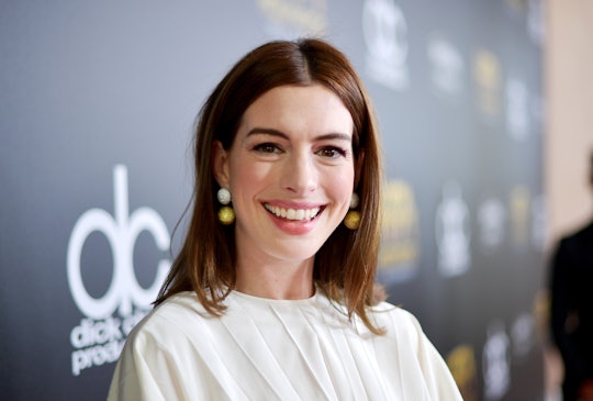 Anne Hathaway smiles during a red carpet appearance. 