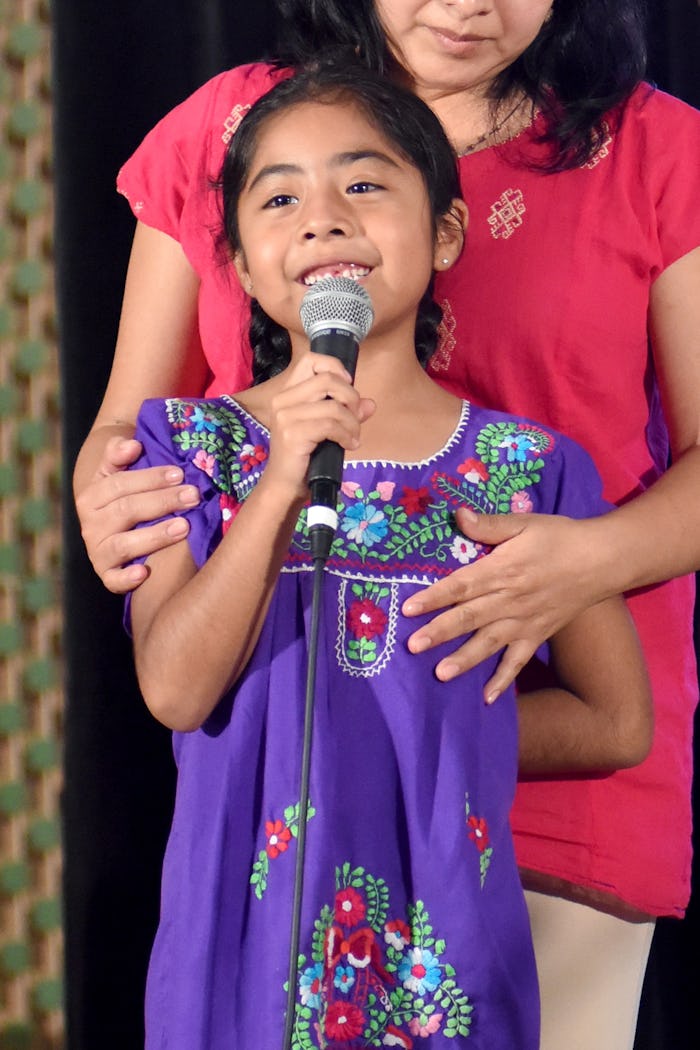 Sophie Cruz, a girl activist, speaking into a microphone on immigration issues