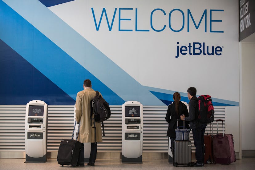 Travelers check in for flights using JetBlue kiosks. 