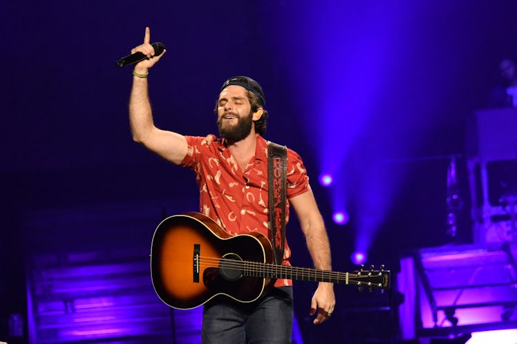 Thomas rhett performing with guitar