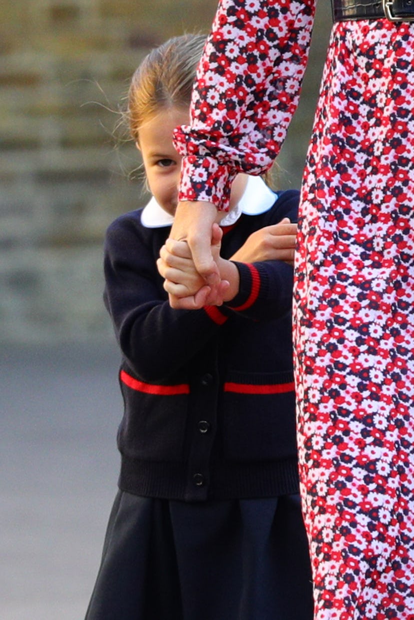 Princess Charlotte hides behind her mom Kate Middleton her first day of school.