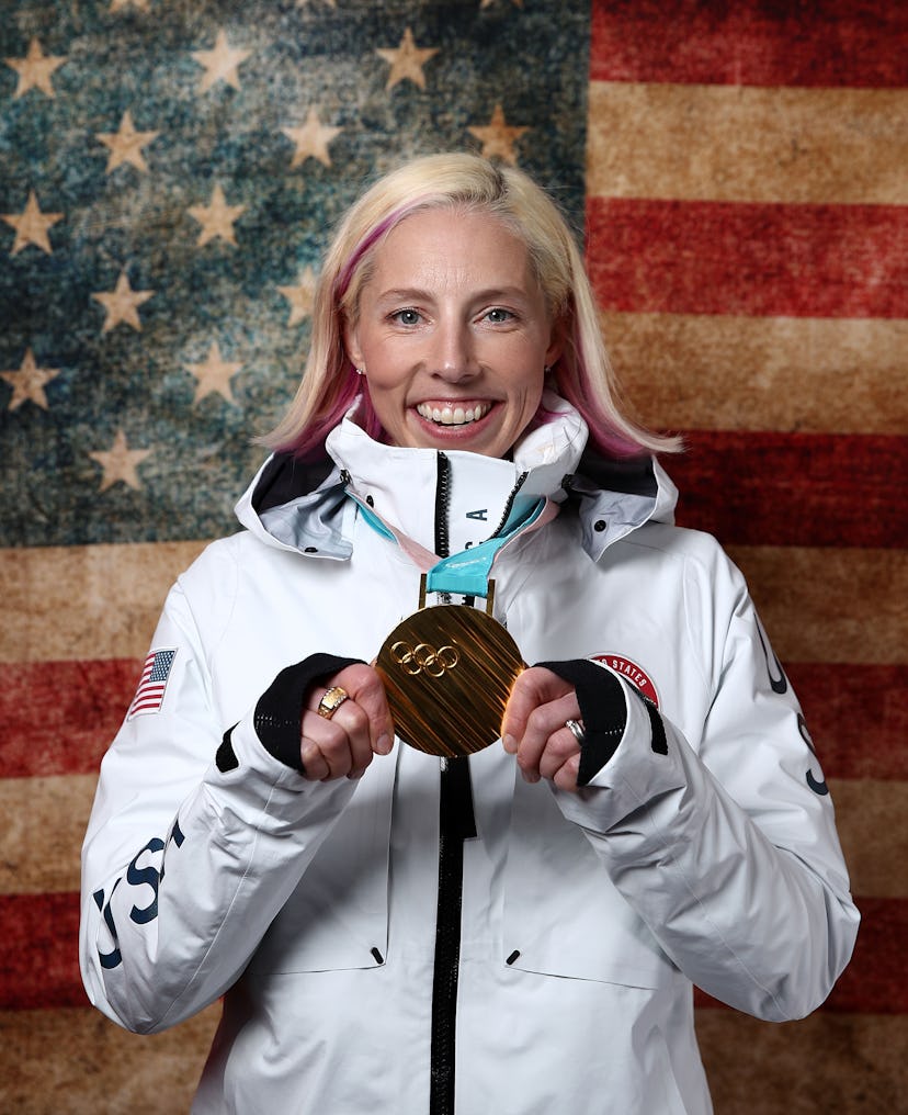 Kikkan Randall holds up her gold medal in front of an American flag. Randall was diagnosed with brea...