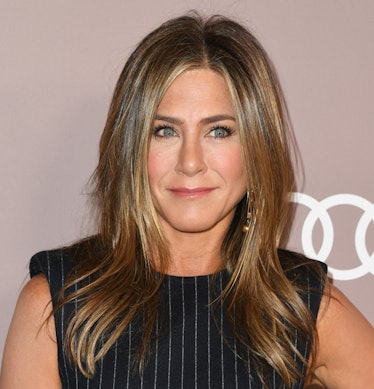 Jennifer Aniston hits the red carpet in a striped black dress.