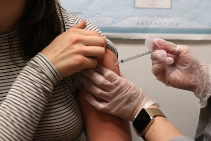 A person gets a flu vaccine, which can help people manage their anxiety around the flu