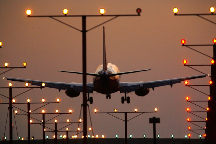 A plane taking off for a flight at twilight, with runway lights shining. The chances of a plane cras...
