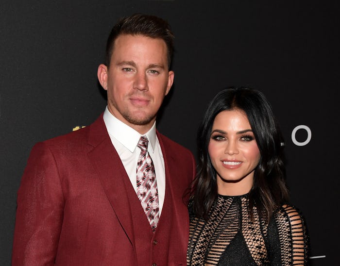 Channing Tatum in a red suit and white shirt and Jenna Dewan in a black dress at a red carpet event