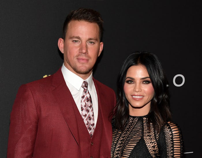 Channing Tatum in a red suit and white shirt and Jenna Dewan in a black dress at a red carpet event