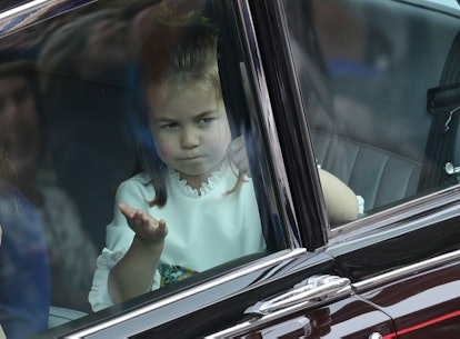 Princess Charlotte shrugs on her way to Prince Harry and Meghan Markle's royal wedding. 