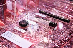 Luxury beauty products in a shop window with shining pink platform