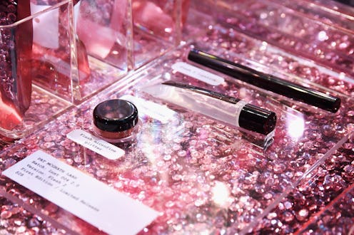 Luxury beauty products in a shop window with shining pink platform