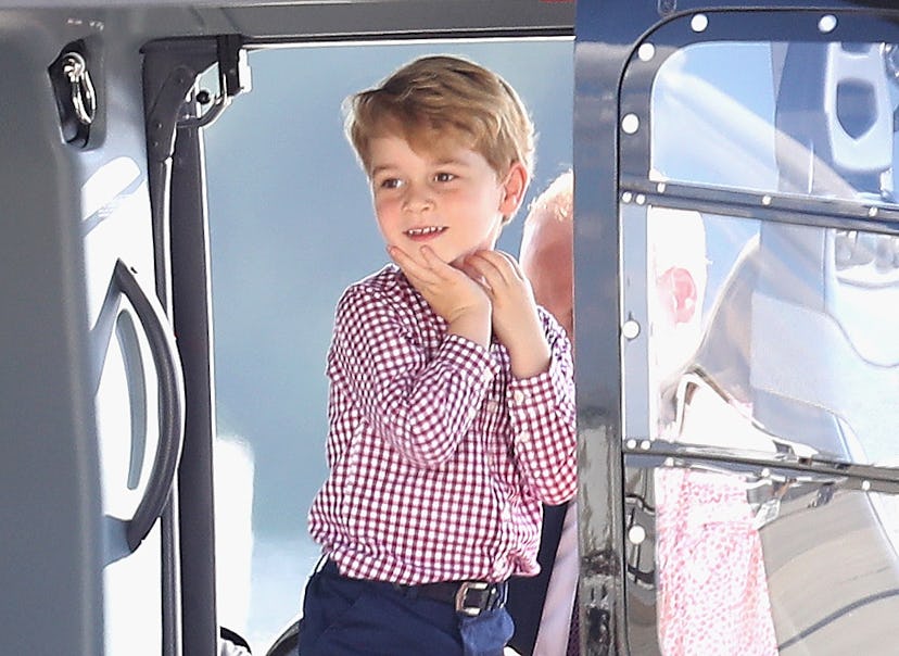 Prince George plays in a helicopter.
