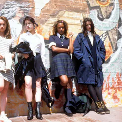 The cast of 'The craft' leaned on a wall with graffiti.