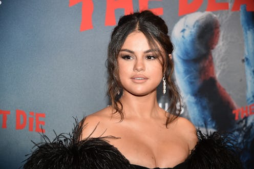 Selen gomez in a black evening dress with feathers on the sleeves at a red carpet event
