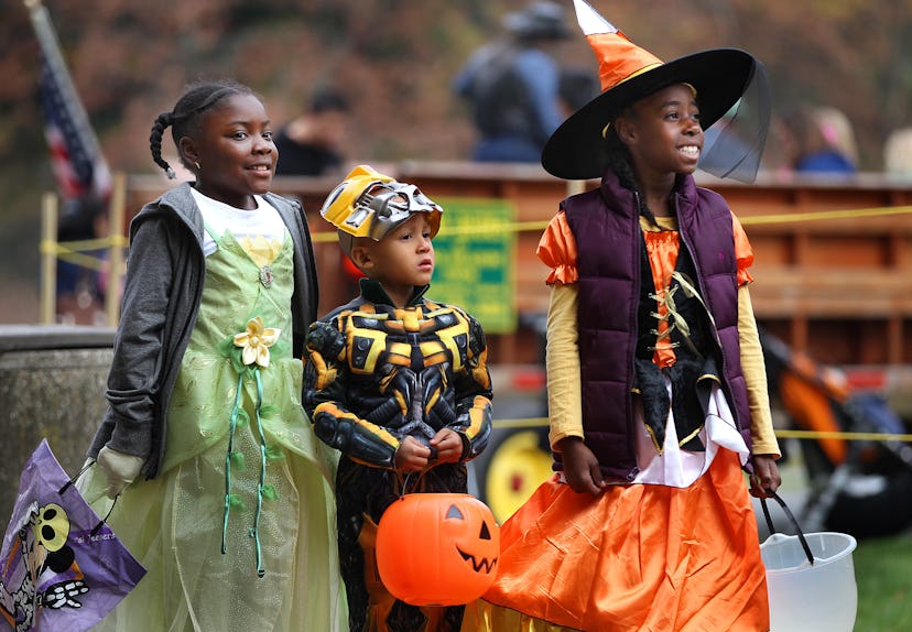 Three children dressed up for Halloween and ready to trick-or-treat. There are plenty of ways to cel...