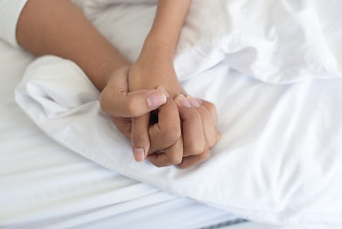 A man and woman holding their hands while having sex