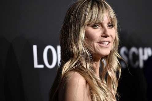 A closeup of Heidi Klum with slight waves in her hair posing at an event