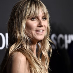 A closeup of Heidi Klum with slight waves in her hair posing at an event