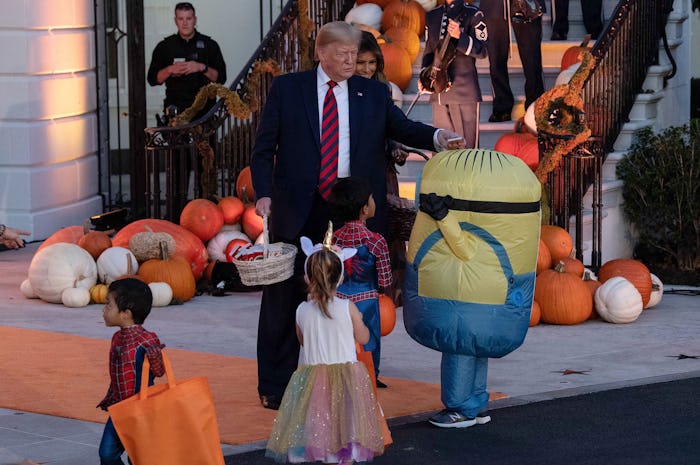  President Donald Trump put Halloween candy on a trick-or-treater's head and the moment has gone vir...