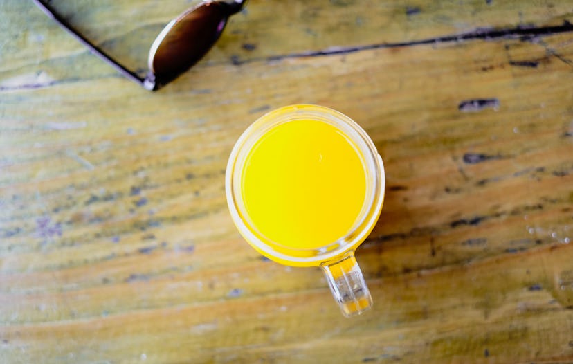 A glass of orange juice on a wood table. Orange juice is a healthy drink.