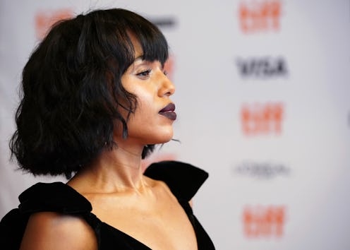Kerry Washington posing in a black evening dress at a red carpet event