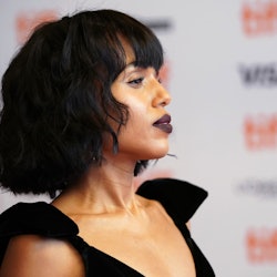 Kerry Washington posing in a black evening dress at a red carpet event