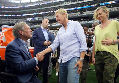Ellen Degeneres and wife Portia DeRossi shake hands with an official at an NFL game