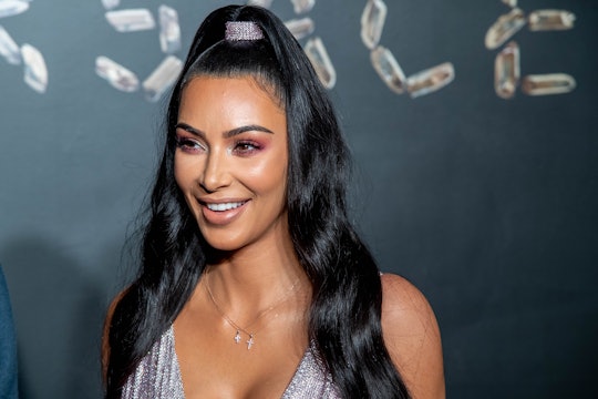 Kim Kardashian, mother of North, Saint, Chicago, and Psalm, poses for a photo. 