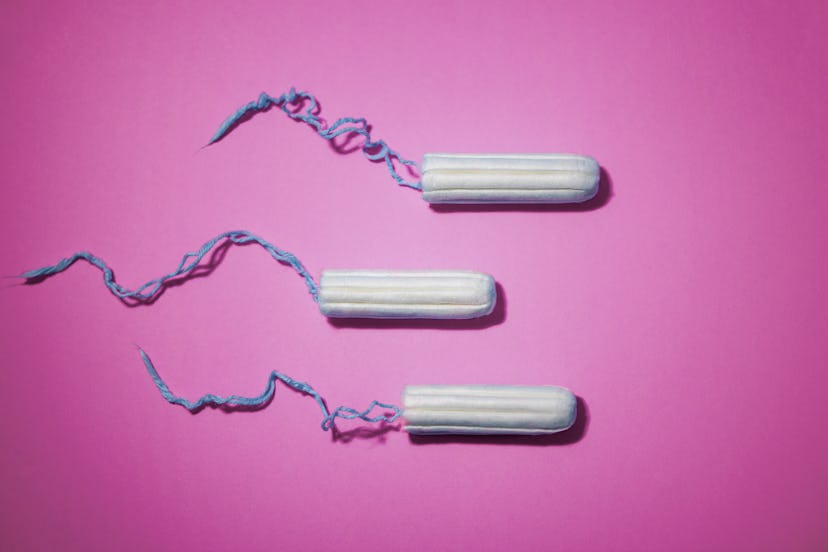 Three tampons on a pink background. Period tracking apps can be useful if used responsibly