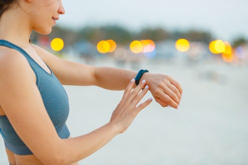 A woman reads her smartwatch for information from her period-tracking app.