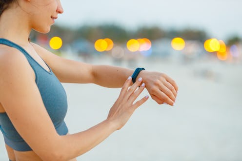 A woman reads her smartwatch for information from her period-tracking app.