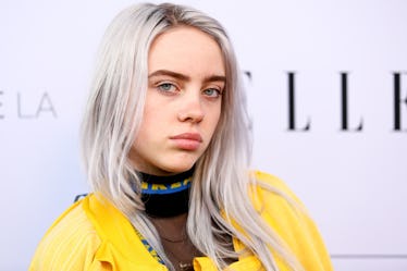 Billie Eilish rocks a vibrant yellow ensemble at an event for Elle Magazine.