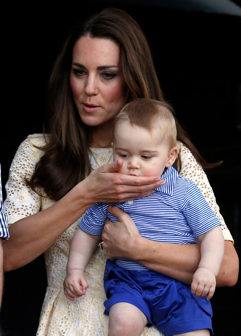 Kate Middleton wipes Prince George's drool on her dress.