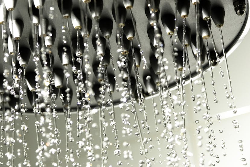 A showerhead with water streaming down. Taking a shower can help you clean off after sex, if that's ...