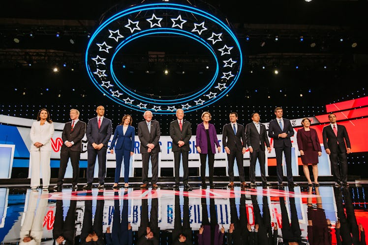 Four women presidential candidates, with eight male candidates, on stage for the debate
