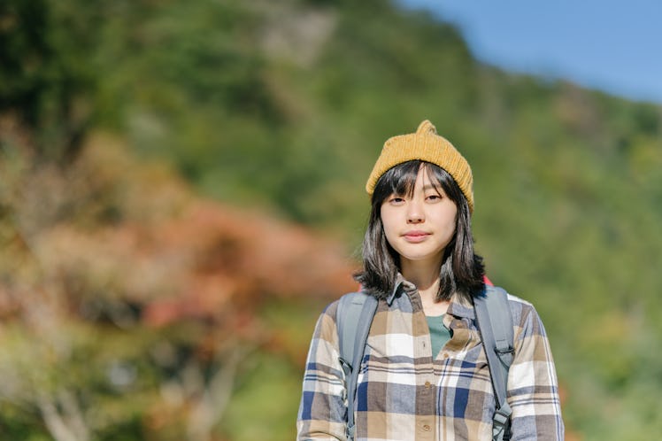 Woman looks thoughtfully at the camera. 