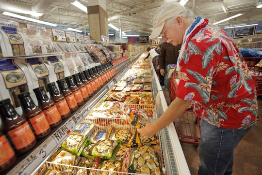 A man shopping the frozen food section at trader joe's