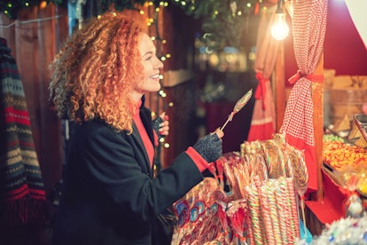 A woman shops at a Christmas market. Shopping for deals can create a positive emotional response.  