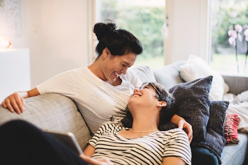 Two people cuddle on the couch. Relationship advice doesn't always apply for people living with trau...