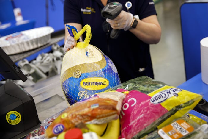 a Walmart cash register with groceries, including a Thanksgiving turkey