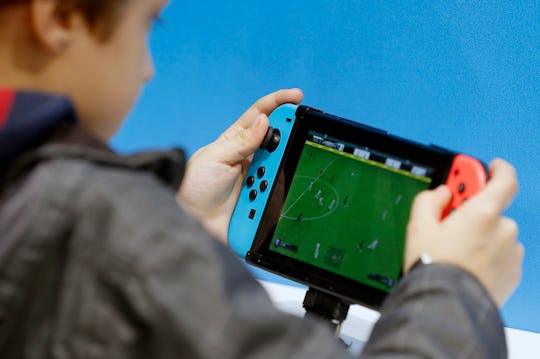 a boy playing Nintendo switch