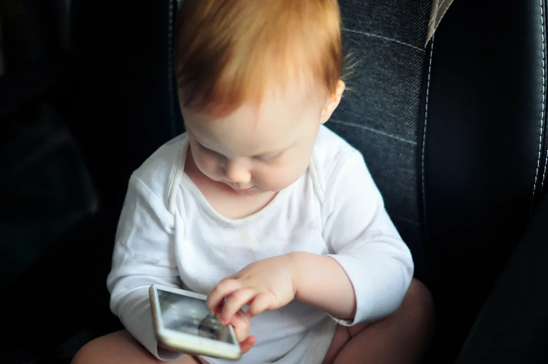 Small Baby Using Phone Why Do Babies Love Cell Phones? Bright Screens Are Only Part Of It