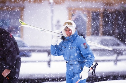 Smiling in the snow, Princess Diana wore white accessories.