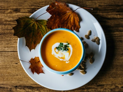 A bowl of fall-themed soup surrounded by leaves on the bottom plate. Setting boundaries with your fa...