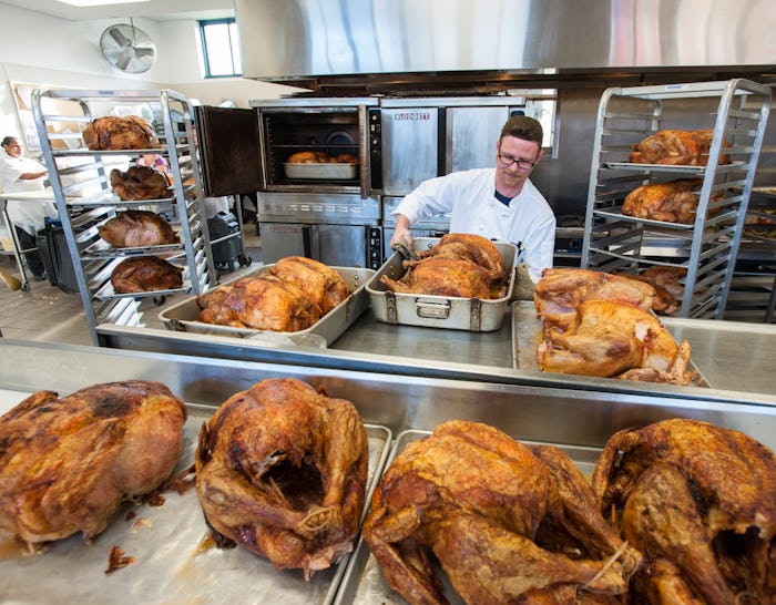 A chef preparing Thanksgiving turkeys at a shelter